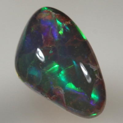 SOLID SEMI BLACK OPAL Large, bright rolling flashes of orange, green and blue
